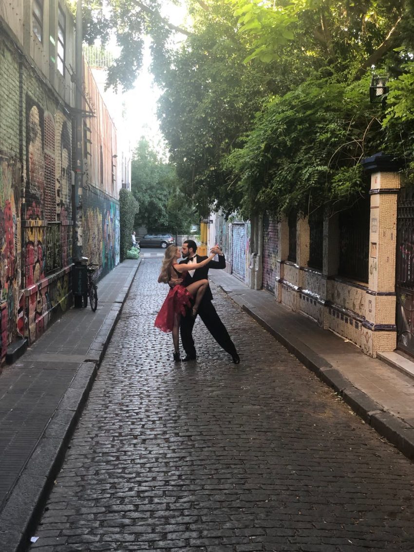 man and woman dancing in middle of alleyway
